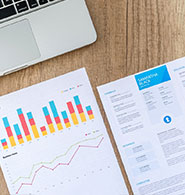 Pile of papers with business graphs